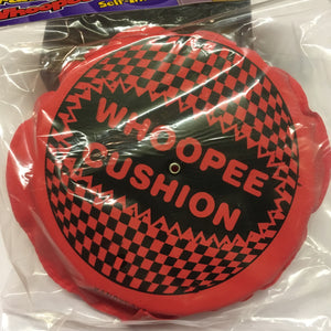 pink self inflatable plastic with text 'whoopee cushion'