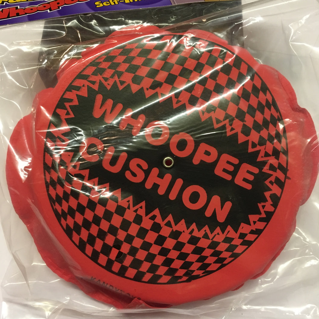 pink self inflatable plastic with text 'whoopee cushion'