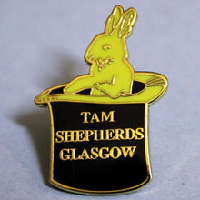 Load image into Gallery viewer, Black and yellow enamel shop logo (rabbit in a top hat) pin badge with raised gold lettering reads 'tam shepherds glasgow'. 21mm width by 30mm height