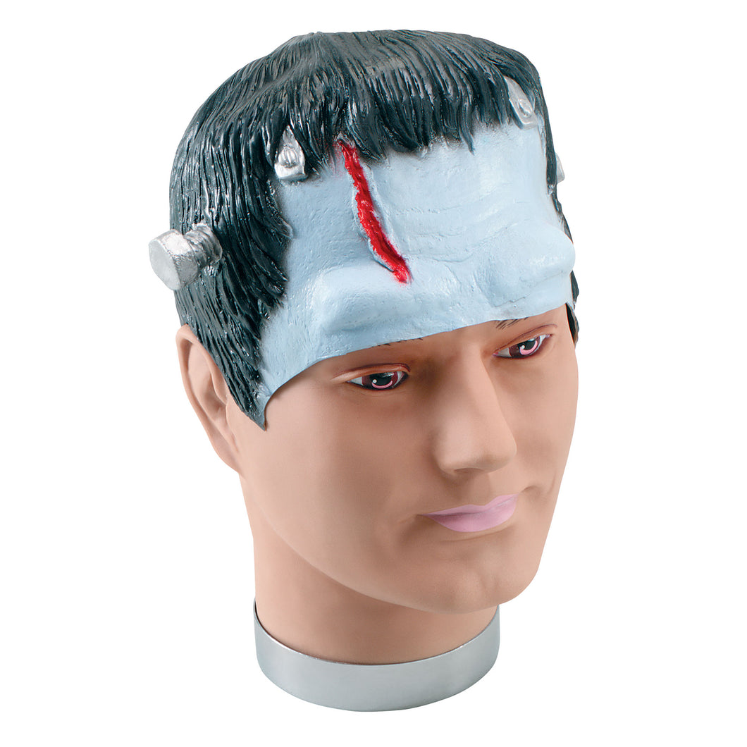 Made of rubber this covers your head and forehead. It has black hair and bolts at either side with a red cut down the front.